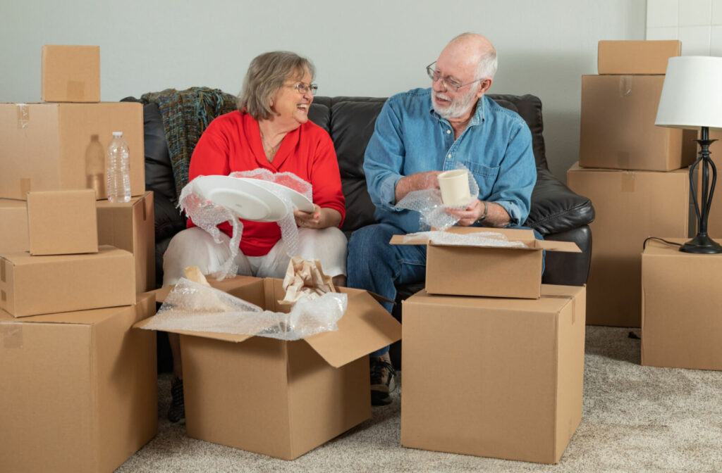 A senior couple happily unpacking their belongings after moving into an inviting villa at Somerby Mount Pleasant.