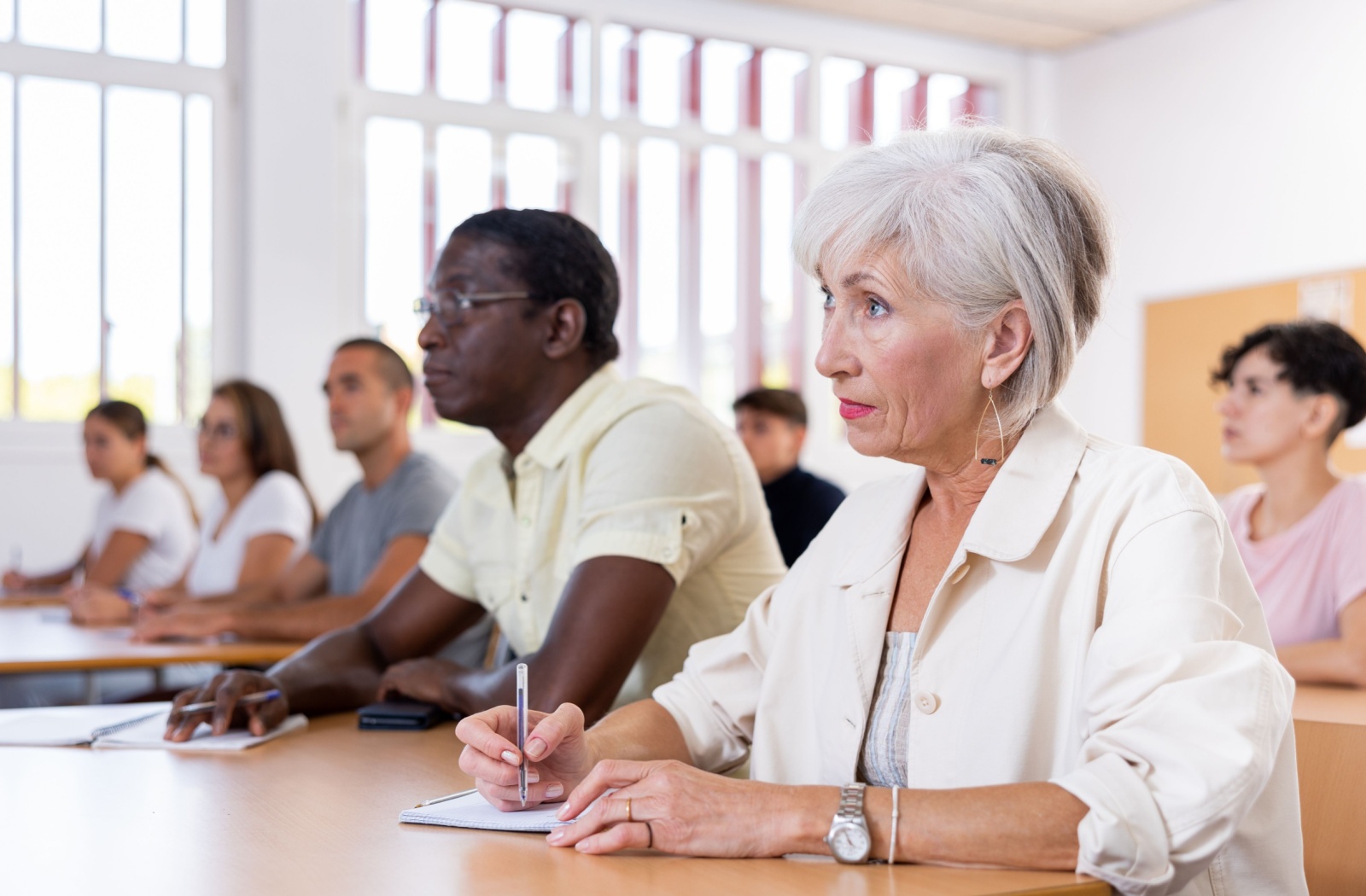 A senior concentrates in a continuing education class they're participating in.
